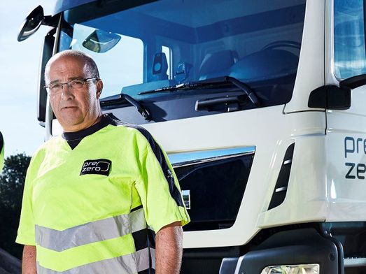 two blue collar worker prezero in front of truck on a plant