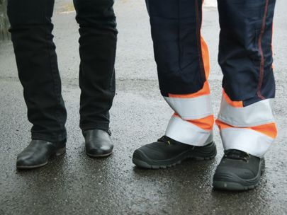 Två par fötter i arbetarkängor och boots