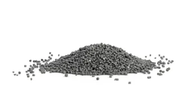 Pile of gray plastic granules on a white background