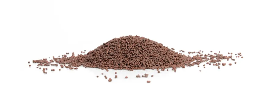 Pile of brown plastic granules on a white background