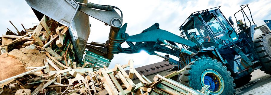 Tractor unloading wood