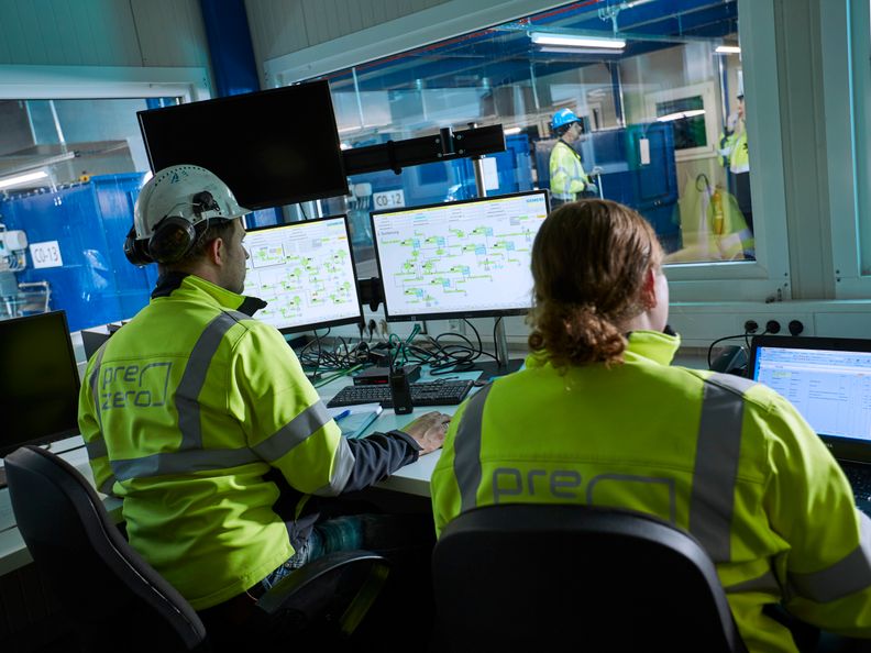 Two Blue Collar Employees are working on their computers  in the office