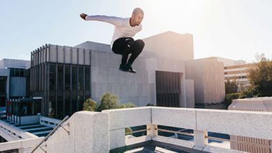 Men jumping on the roof of a building