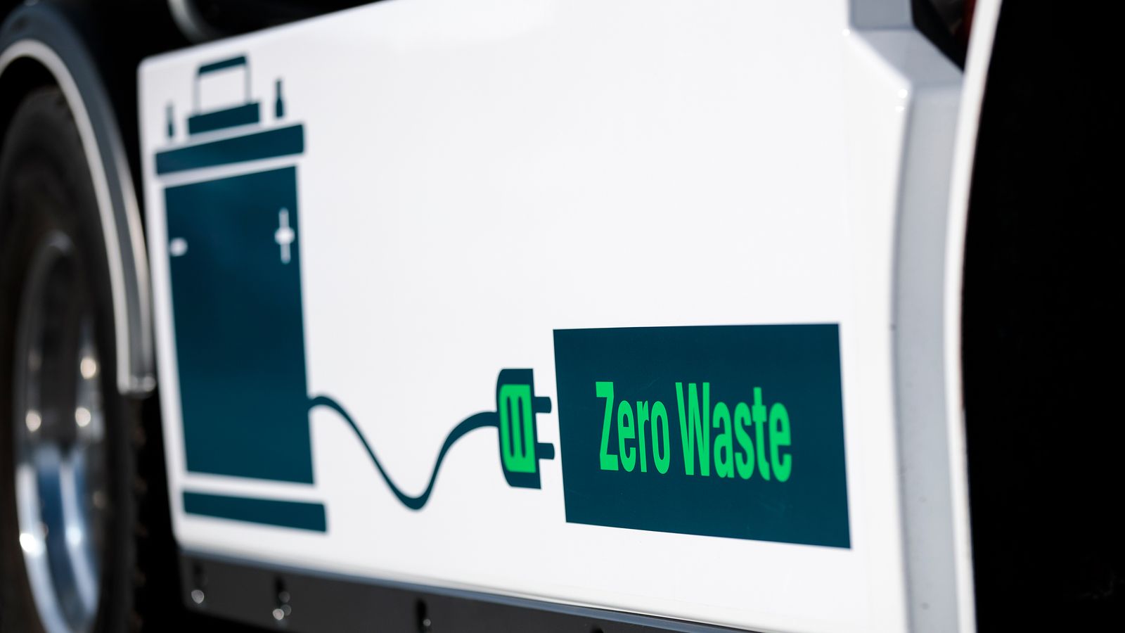 Sidan på en lastbil med dekal som visar batteri med kabel till texten Zero Waste