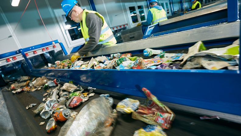 Employee sorting garbage on the sorting belt