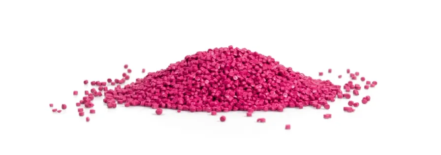 Pile of pink plastic granules on a white background