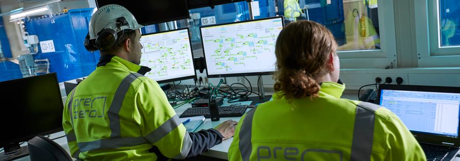 Two Blue Collar Employees are working on their computers  in the office