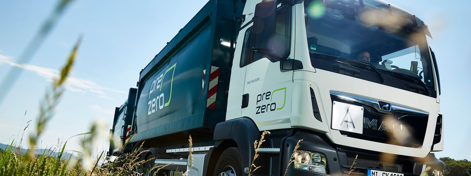 Prezero truck drives next to field